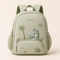 KidaPack Dino vert sauge sur fond beige